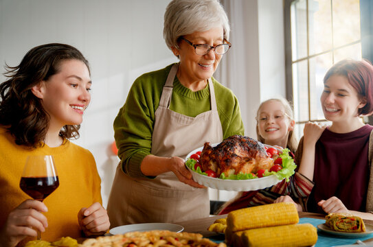Happy Family Gathering Sharing Festive Dinner and Celebrating Together at Home