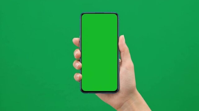 Female Hand Holding Smartphone and Tapping Display on Chroma Key Green Screen Studio Background