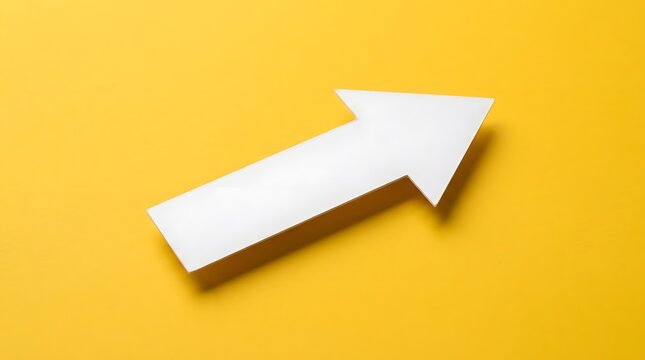 White arrow cutout made of paper  positioned diagonally against bright yellow surface  casting subtle shadow to indicate depth and forward motion