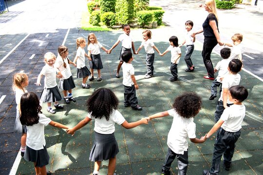 Children playing circle game outdoors