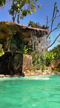 Artificial Waterfall and Turquoise Swimming Pool in Phu Quoc, Vietnam during Sunny Day