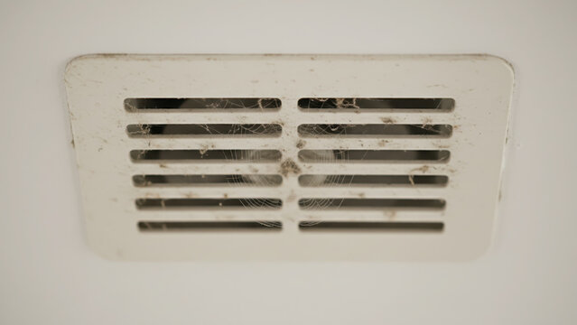 Dirty Ventilation Grill Covered in Dust and Spiderwebs