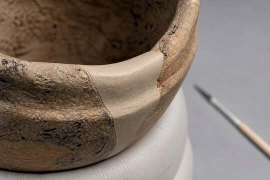 Archaeological artifact conservation laboratory - a reversible fill supporting a weathered pottery rim