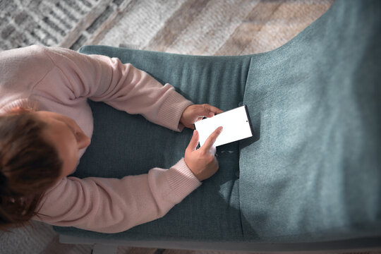 Woman using smartphone at home &ndash; online communication and digital lifestyle.