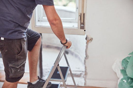 Workers changing old windows and doors in the apartment.