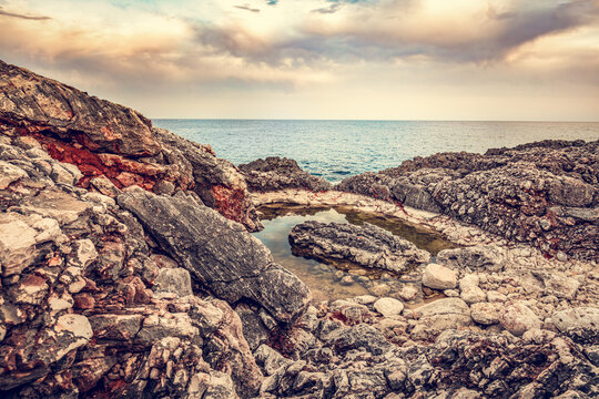 Sunset rocks along coast in scenic Cala d'Or, Mallorca, Spain.
