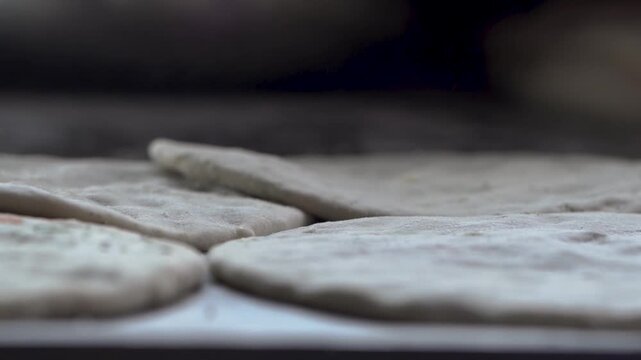 Close-up of raw flatbread ready to be cooked in a tandoor.