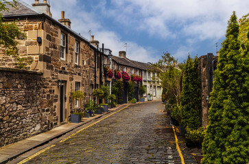 Cobbled lane with sandstone houses and St Stephen's Church tower in Circus Lane Edinburgh © gdefilip