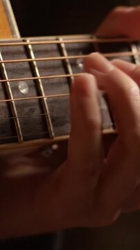 An Intimate Close-up of Guitar Strings and Frets Highlighting the Art of Music Creation Through Skillful Finger Placement and Strumming Techniques