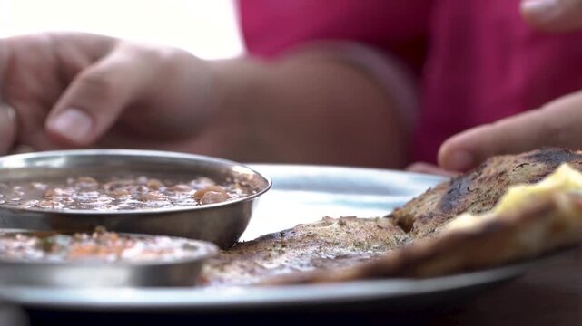 Close-up of serving chole with tandoori parantha and chutney.