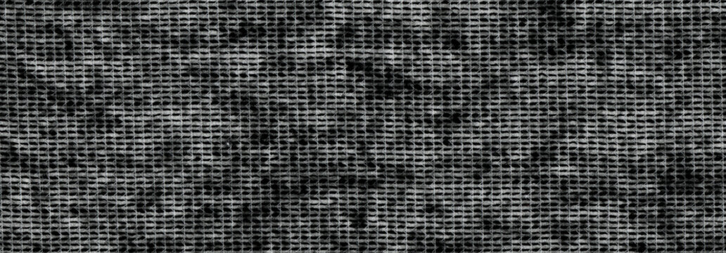 Netting gaps in gray gauze with uneven rectangular openings and loose thread crossings, an open woven fabric background with uneven rectangular gaps and loose fibers following the yarn crossings