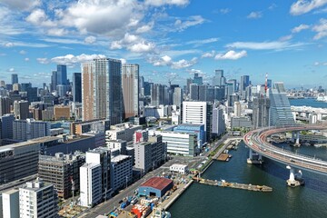 Obraz premium Aerial drone photo of coastal cityscape with waterway and crane in Minato, Tokyo
