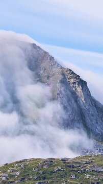 time lapse of the fog flowing over a mountain ialong the coast of Norway. Vertical video.