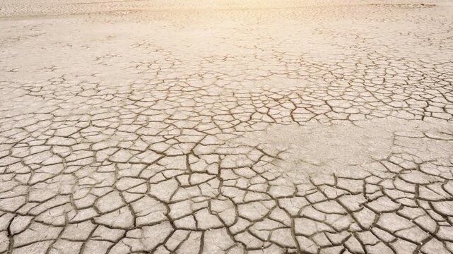 Aerial shot looking down at the cracked surface of a dry lake.
