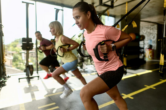 Women Leading Suspension Trainer Workout in Gym