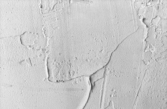 White textured concrete wall ideal for construction, architecture, backgrounds, and design projects requiring a rough, bumpy, and heavy material.