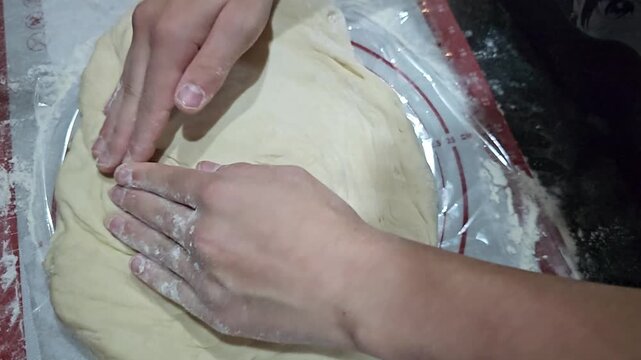 Kneading dough to prepare for baking