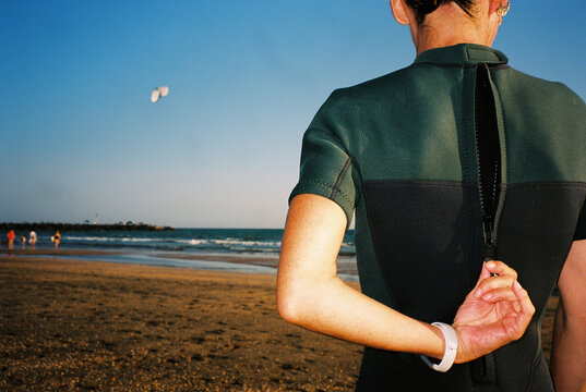 Woman Zipping Wetsuit