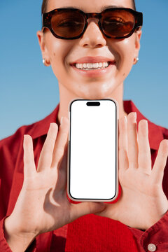Portrait of woman holding phone mockup with blank screen for app