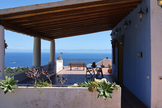 Covered terrace with succulents and distant sea horizon
