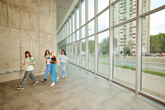 Small group of students walks inside the building