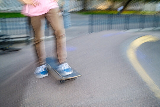 Skater Rides Skateboard on Park Pathway During Afternoon