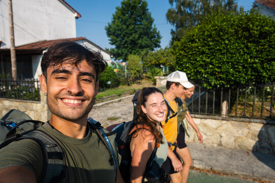 Group grins along a rural Camino street