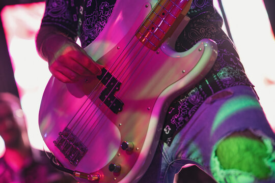 Bass guitarist performing on stage with passion