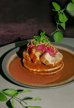 Roasted Pork Meat with fried potato pancakes, fritters, brown Sause