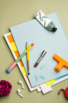 Back to school concept with scattered objects on blue notebook
