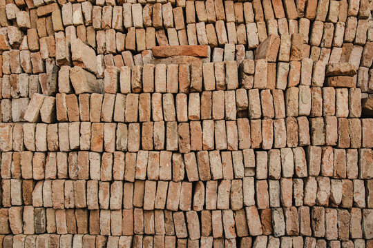 Stacked old bricks creating a textured wall background