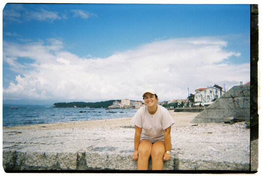 Young woman smiling enjoying summer vacation at the beach