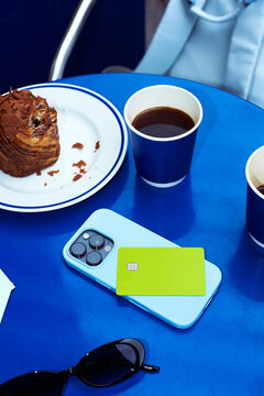 Coffee break at a table with food and phone