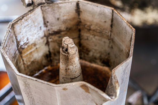Close up of an old moka pot interior with coffee residues