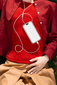 Woman wearing phone mockup with white screen for music app