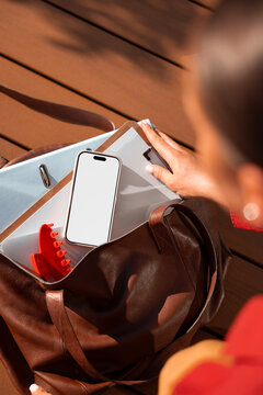 Woman smartphone mockup with blank white screen beside travel