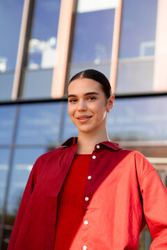 Portrait of confident woman in red modern office on a city street