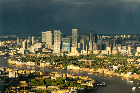 Canary Wharf Skyscrapers Lit by Sun Against Storm Clouds