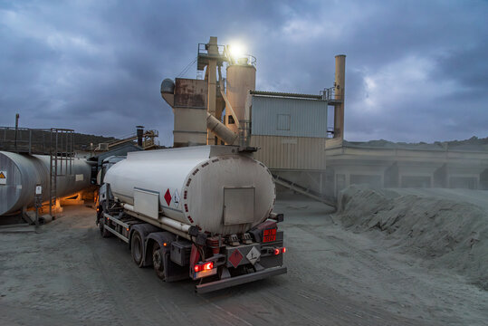 Small tanker truck delivering diesel fuel to an industrial asphalt plant