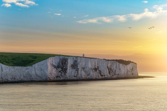 Dover White Cliffs and Lighthouse at Sunrise, England