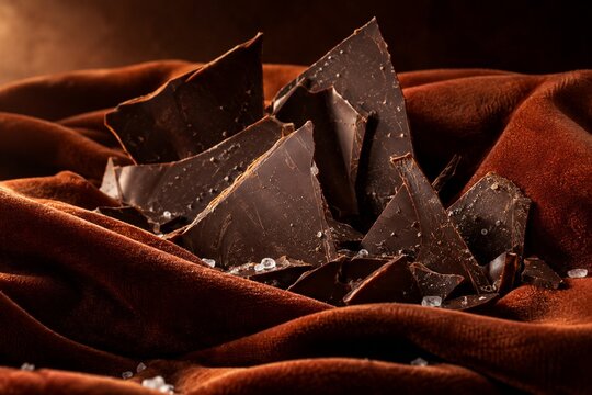 Dark chocolate shards and sea salt on rust velvet