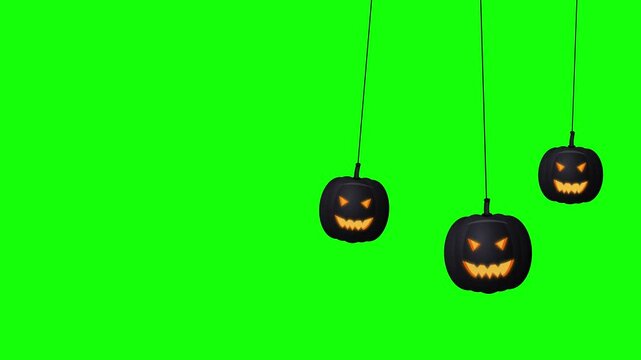 Black jack o lantern pumpkins hanging on a green screen