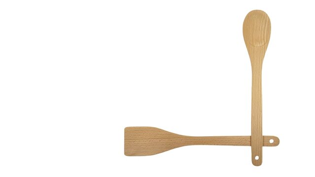 Top view of a wooden spoon and a spatula crossed over, isolated on white background with space for text, ideal for kitchenware banner, culinary blog, recipe layout, or cooking template designs.
