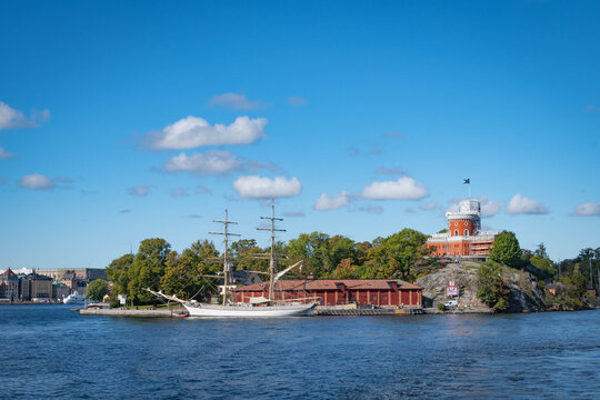 Sweden Stocholm September 24 2026 - red brick citadel of Kastellet on the islet of Kastellholmen in central Stockholm, Sweden, alongside a sailing vessel - the brig Tre Kronor af Stockholm.