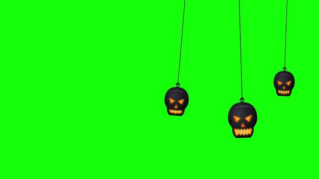 Hanging halloween skull ornaments swinging on green screen