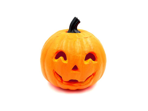 Decorative pumpkin with carved eyes and mouth, isolated on a white background. Halloween theme.