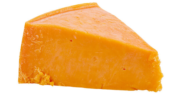 Wedge of bright orange cheddar cheese textured and crumbly, isolated on transparent background