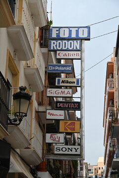 Vintage Banners of Leading Photography Brands on a Building Facade Above a Camera Store