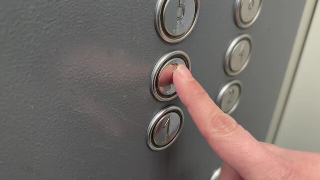 Close-up of person finger pushing metallic number three button inside an elevator. Daily urban transportation background, modern lift interior control panel details.