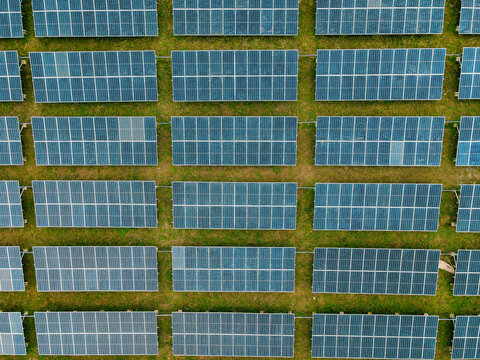 Aerial view of rows of solar panels installed on a grassy field in Ogun State, Nigeria.